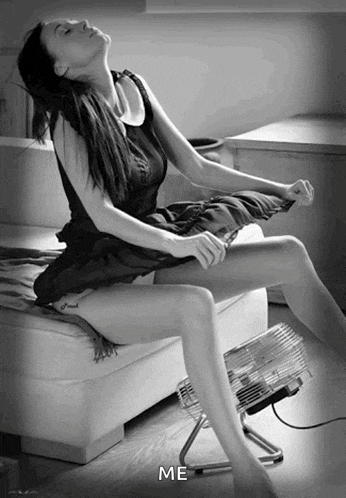 a black and white photo of a woman sitting on a couch next to a fan with the caption " me " below her