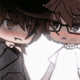 a couple of anime characters standing next to each other .