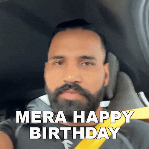 a man with a beard is sitting in a car with the words mera happy birthday written on his face