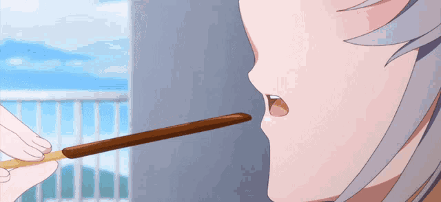 a close up of a person eating a stick