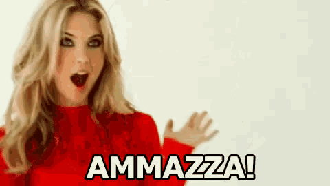 a woman in a red sweater with the word ammazza written on it