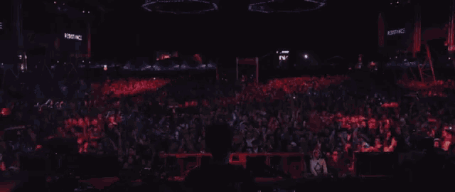 a crowd of people at a concert with a screen that says ' empire ' on it
