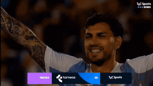 a soccer player is smiling in front of a screen that says " tyc sports "