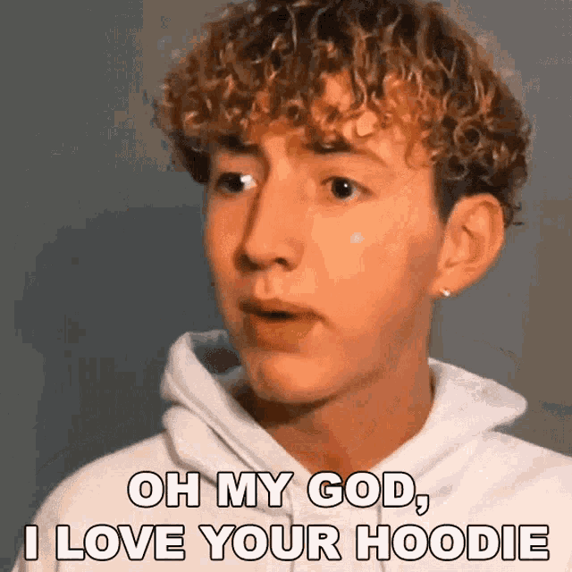 a young man with curly hair says oh my god , i love your hoodie .