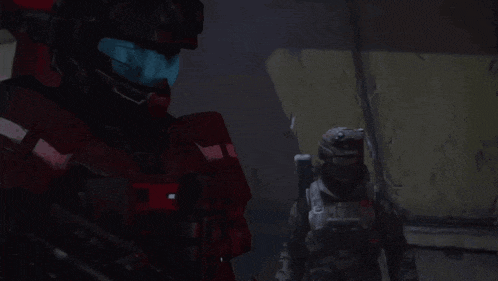 two soldiers are standing in a dark room and one of them is wearing a helmet that says ' halo '