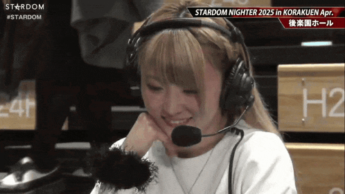 a woman wearing headphones and a microphone with the word stardom on the bottom right