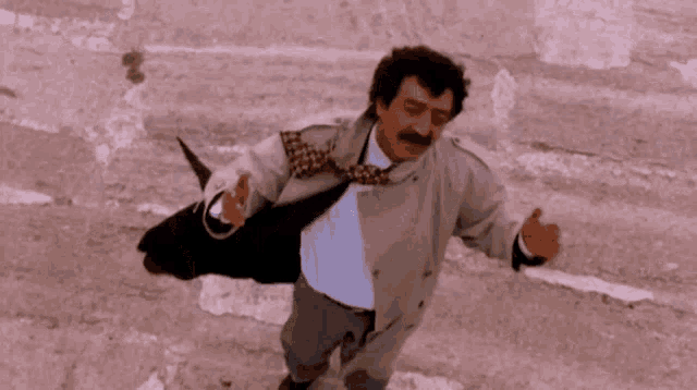 a man with a mustache wearing a trench coat and tie