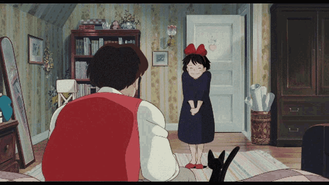 a girl with a red bow on her head stands next to a man in a room