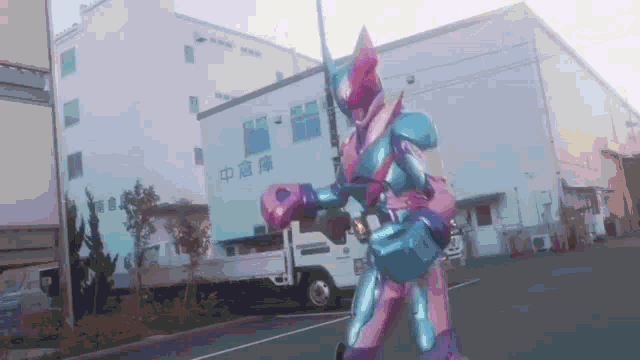 a superhero in a pink and blue suit is standing in front of a building .