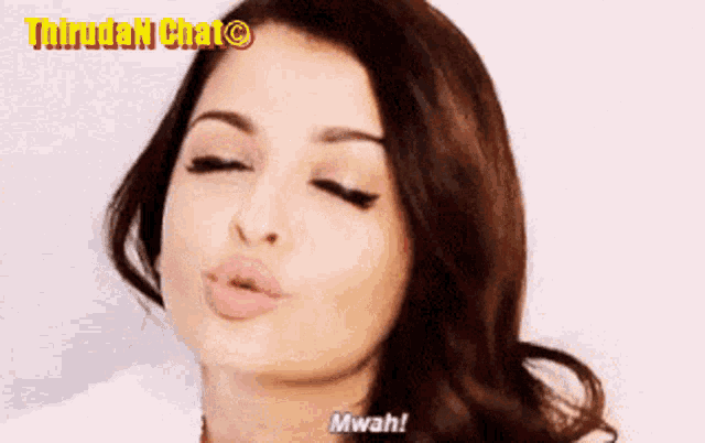 a close up of a woman blowing a kiss with the words mwah on the bottom right