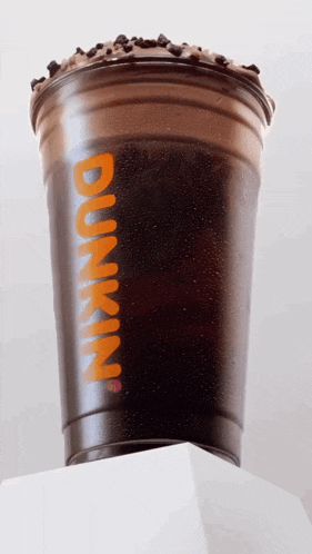 a dunkin ' cup with iced coffee and chocolate chips on top
