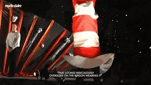 a person wearing a cat in the hat says " that looked ridiculously oversize on the person wearing it "