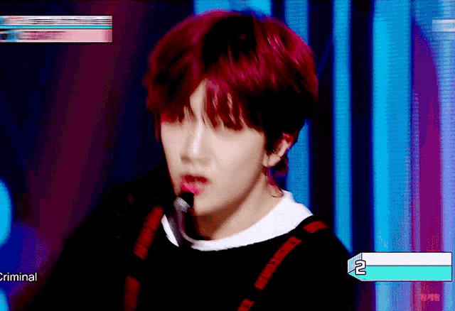 a person with red hair is standing in front of a screen that says criminal 2