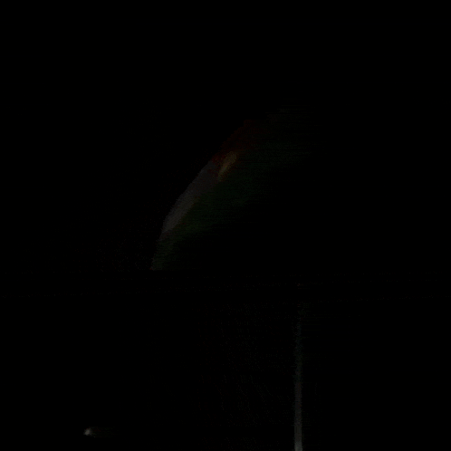 a kurdish flag is waving in the dark