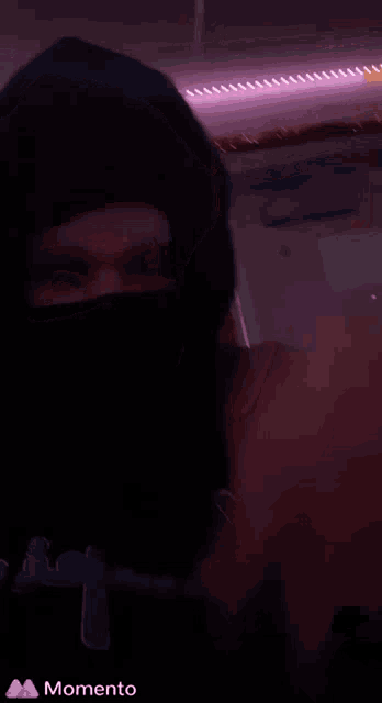 a person 's fist is shown in a blurry photo with a momento icon in the corner
