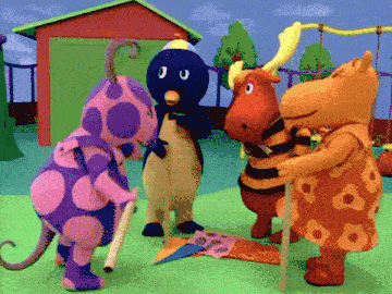 a group of stuffed animals standing next to each other in front of a house