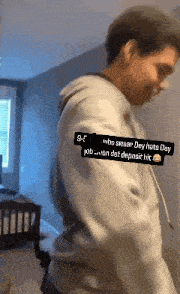 a man is standing in a room with a sticker on his arm that says ' who swear dey hate day job '