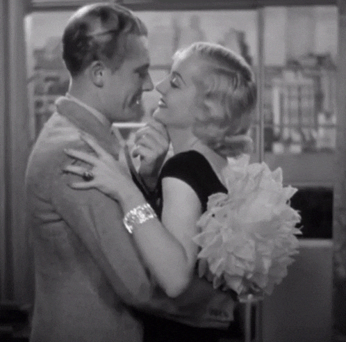 a black and white photo of a man and woman