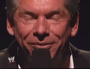 a close up of a man 's face with a wrestling logo in the corner