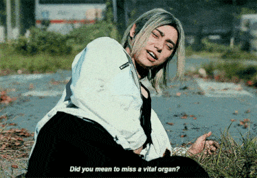 a woman sitting on the ground with the words " did you mean to miss a vital organ " above her