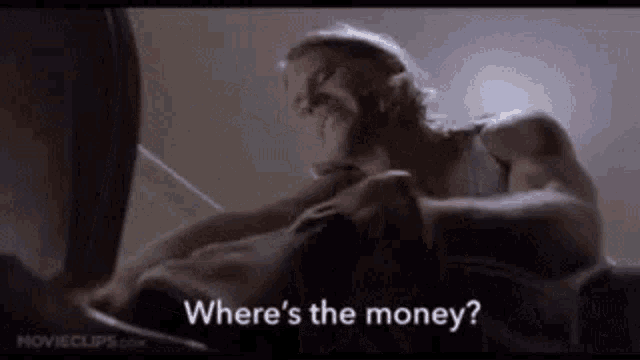 a woman is laying on a man 's chest and asking where 's the money ?