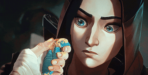 a close up of a cartoon character holding a blue cookie