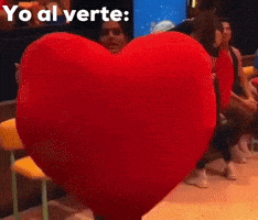 a large red heart with yo al verte written on the bottom