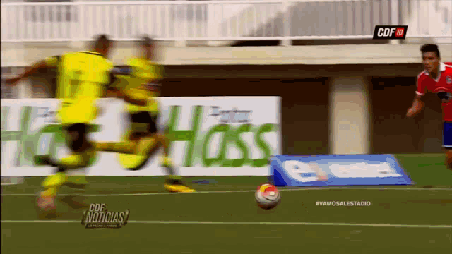a soccer game is being played in front of a hass banner