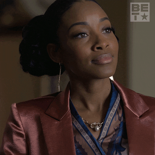a woman in a suit says yeah in front of a bet logo