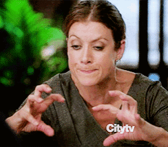 a woman is making a face with her hands in front of a citytv sign