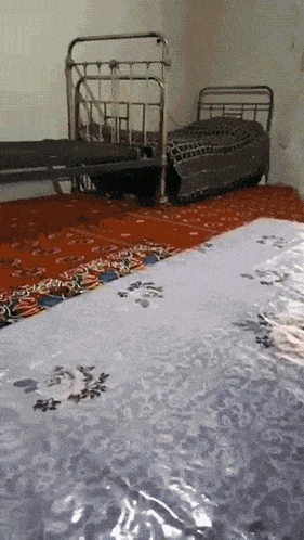 a room with two beds and a blanket that says ' a ' on it