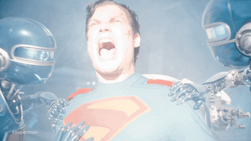 a man in a superman costume is being attacked by robotic hands