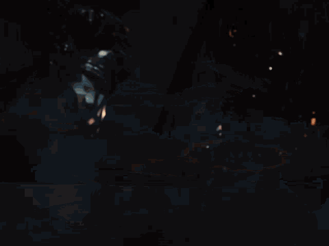 a silhouette of a person in a dark room with a light in the background