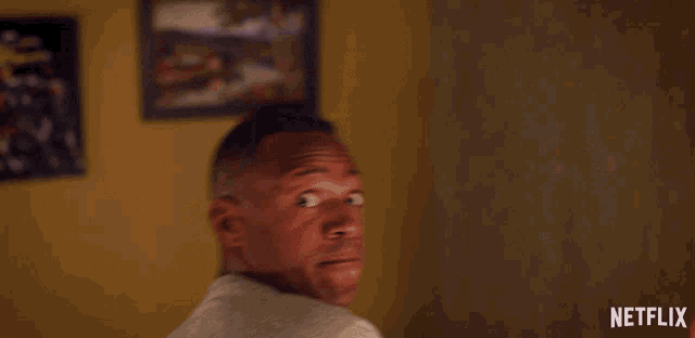 a man is yawning with a netflix logo behind him