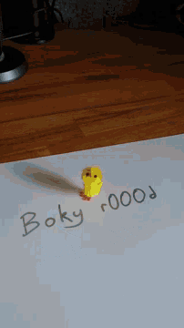 a rubber duck sits on a white board with the words boky poop written on it