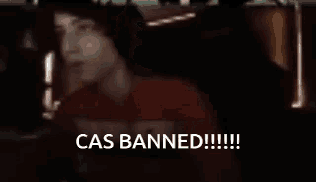 a blurry picture of a person with the words cas banned written in white
