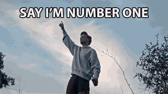 a man is standing in a field with barbed wire behind him and the words say i 'm number one above him