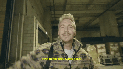 a man says first things first come here in a video