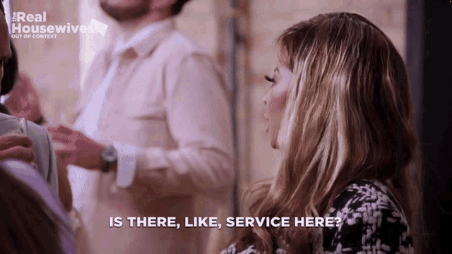 a woman talking to a man with the words is there like service here