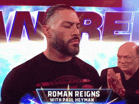 a man in a black shirt with roman reigns on it