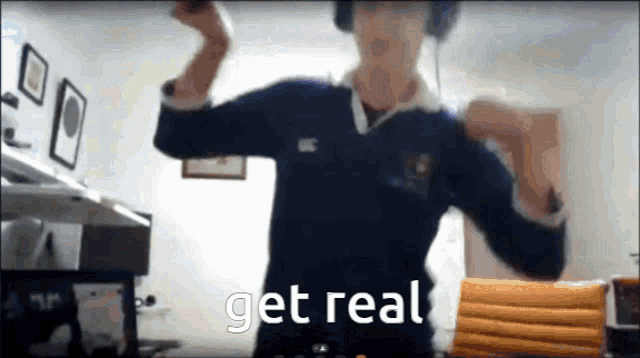 a man wearing headphones is dancing in a room with the words get real on the bottom