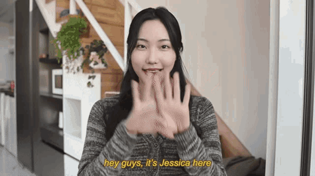 a woman says " hey guys it 's jessica here " in front of a staircase