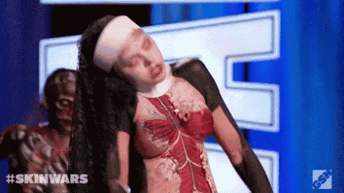 a woman dressed as a nun with a body painted like a skeleton is dancing on a stage .