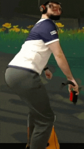 a man wearing headphones is riding a bike in front of a screen