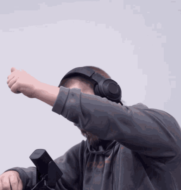 a man wearing headphones and a hoodie that says ' nike ' on it