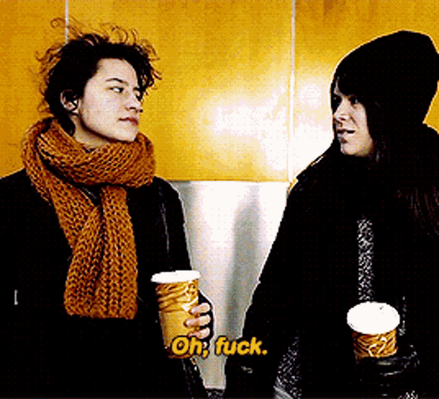 two women are holding cups of coffee and one of them says oh fuck