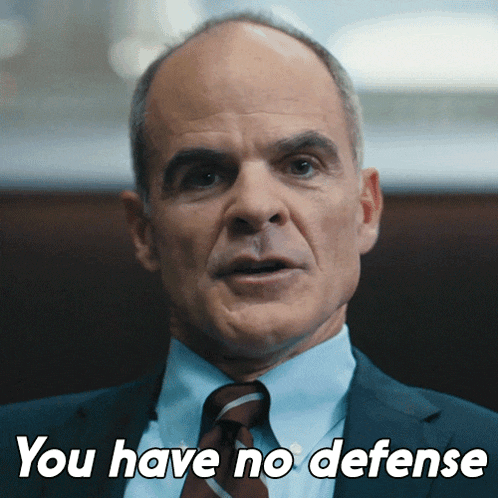 a man in a suit and tie with the words you have no defense below him