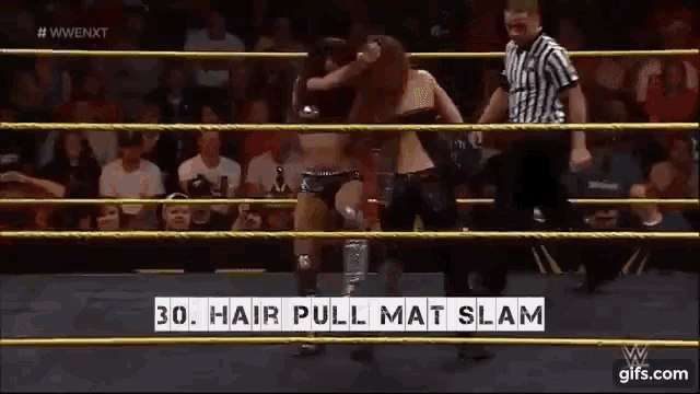 a woman in a wrestling ring with the words hair pull mat slam on the screen