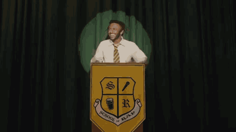 a man is giving a speech at a podium that says school of rap