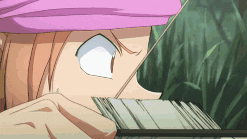 a close up of a person 's face with a pink hat